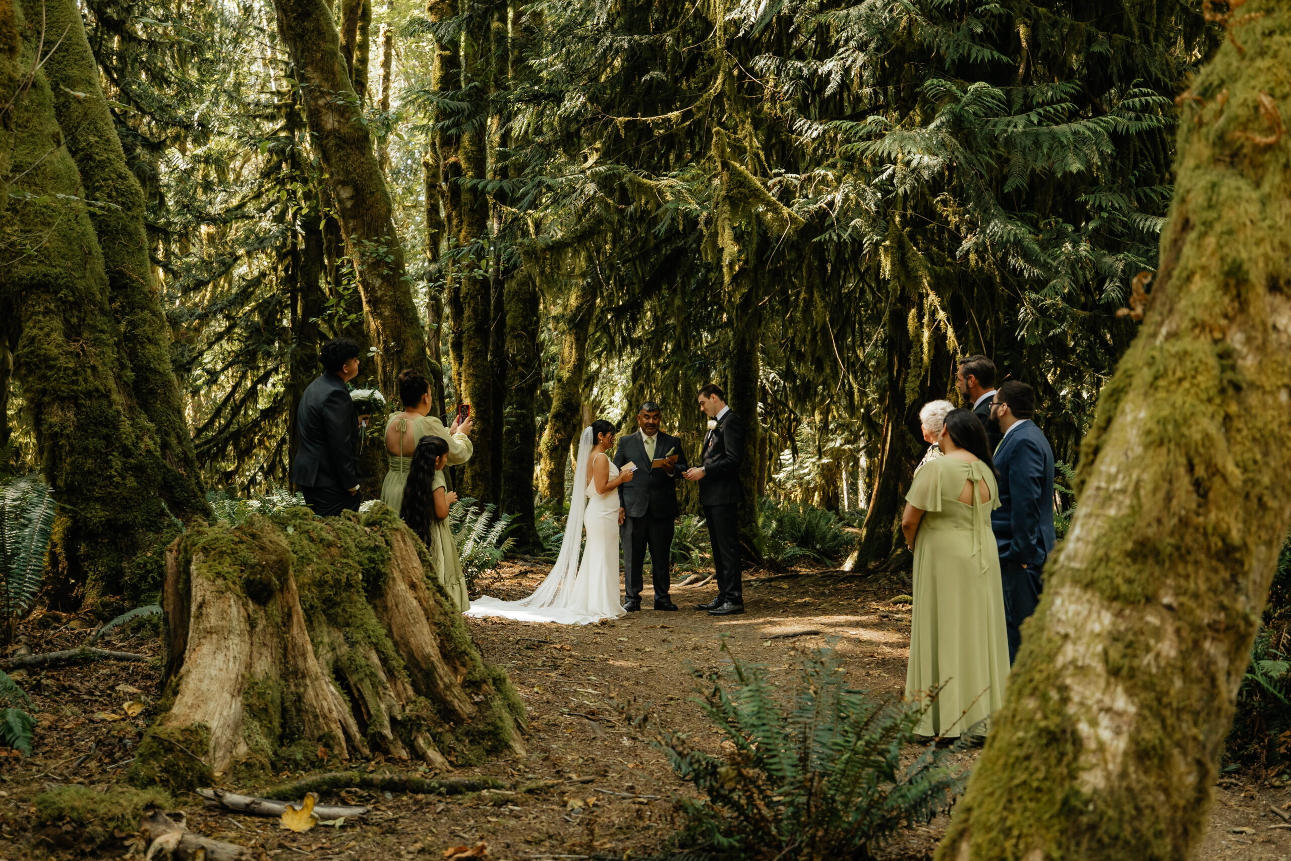Guests gather around bride and groom during their Hoh Rainforest wedding ceremony.