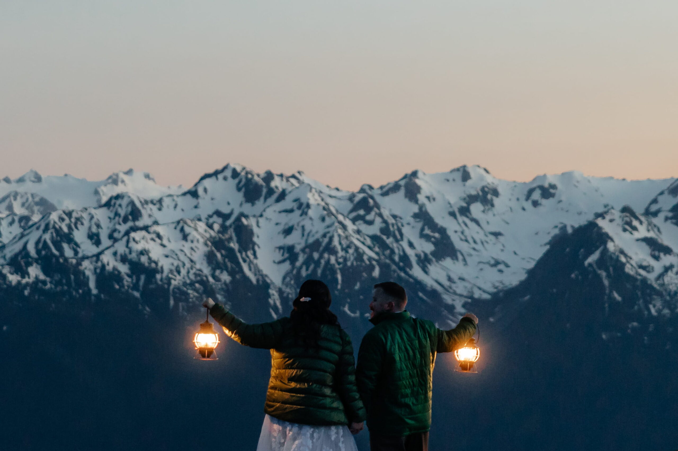 Newlyweds hold lanterns during their Hurricane Ridge elopement after dark. 