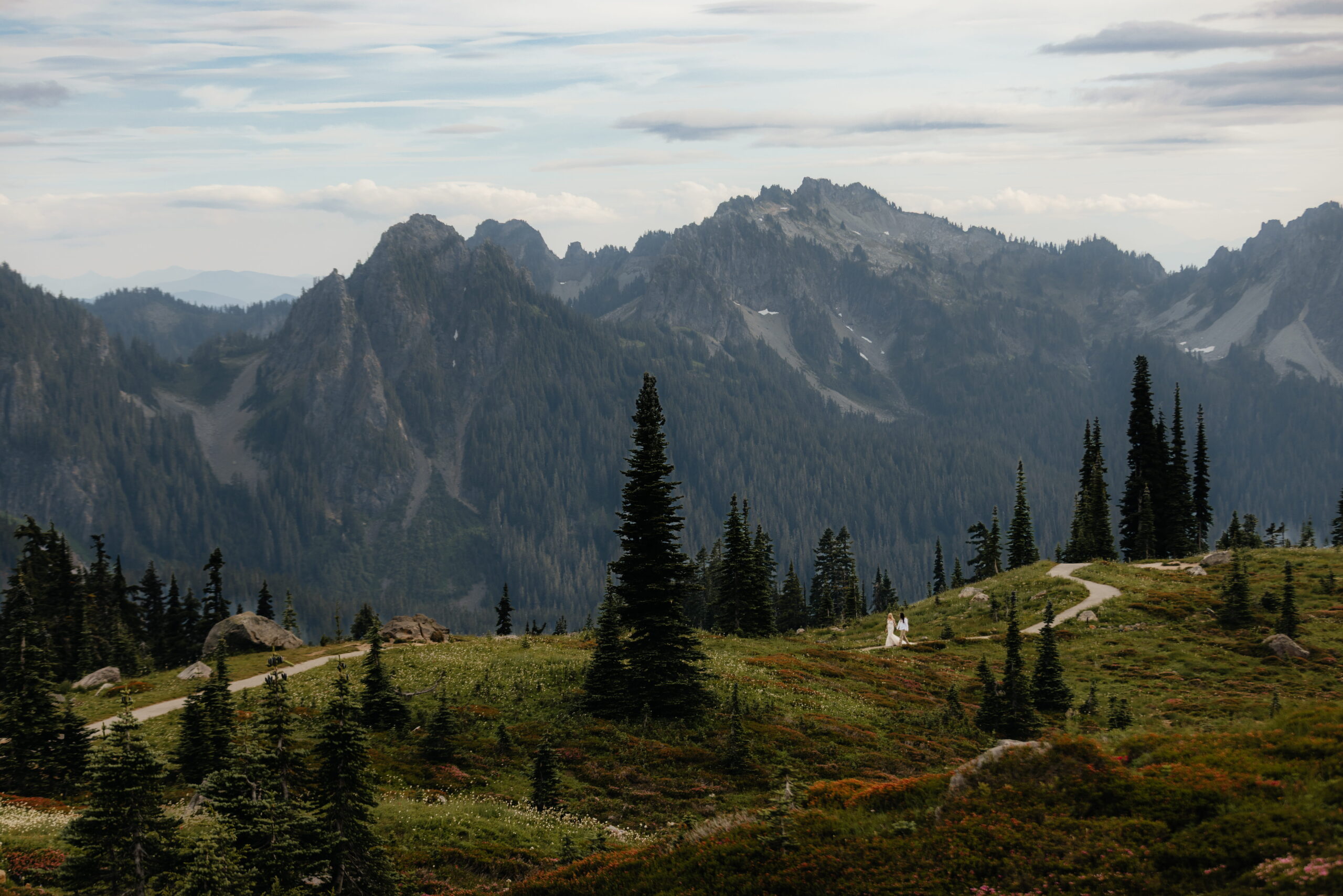 Newlyweds walk the Skyline Trail during their elopement in Mount Rainier National Park, one of the best places to elope in Washington.