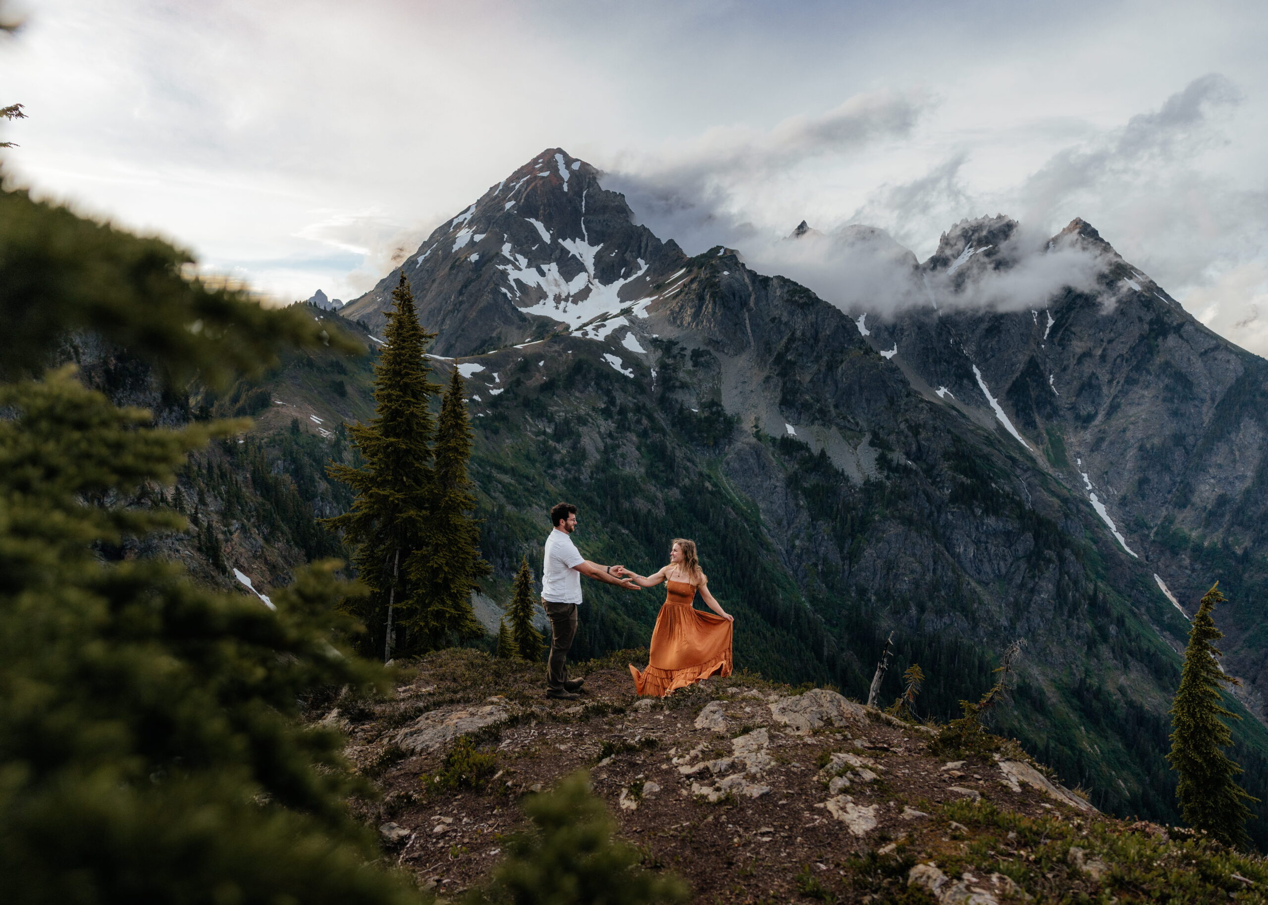 Couples dances on a mountain trail at Winchester Mountain Lookout, one of the top Washington elopement locations. 