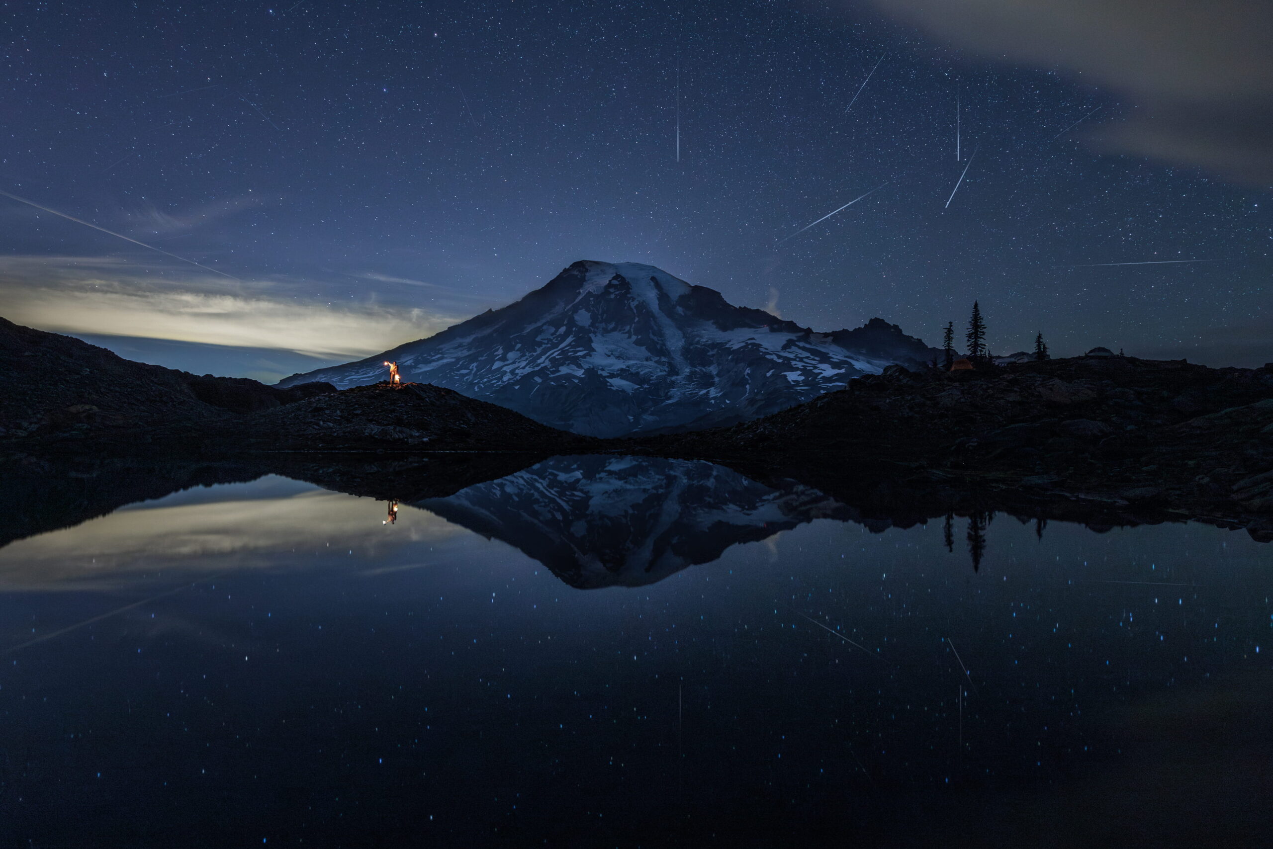 Newlyweds hold lanterns during blue hour at their Mt Rainier elopement.