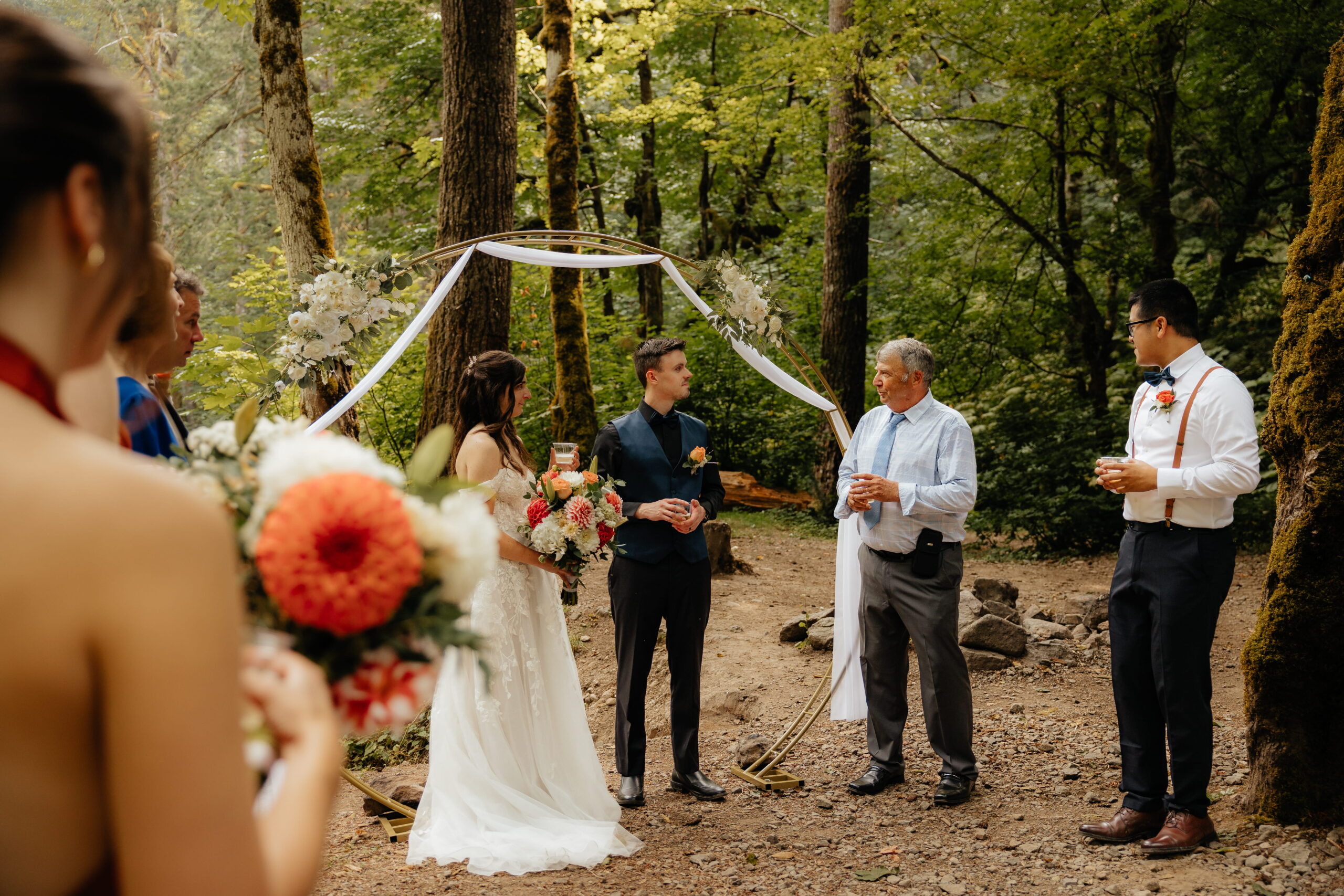 Guest speaks to bride and groom during their Mt Rainier wedding ceremony.