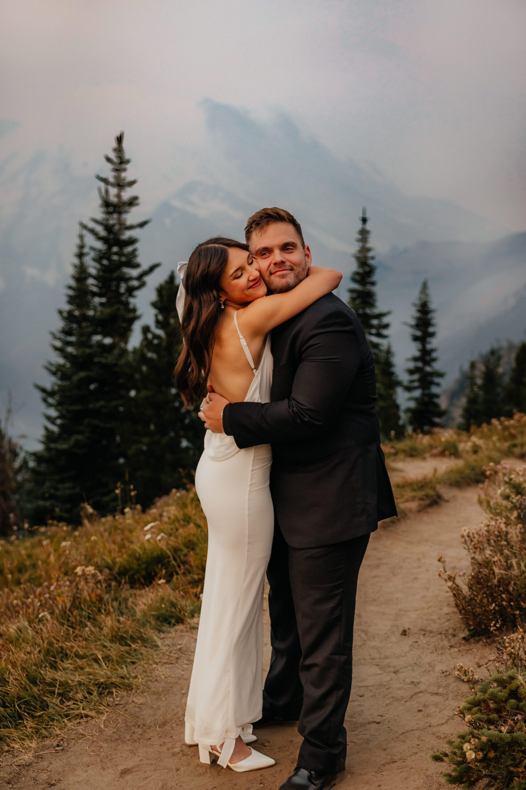 Newlyweds hug after their Mount Rainier National Park wedding ceremony.