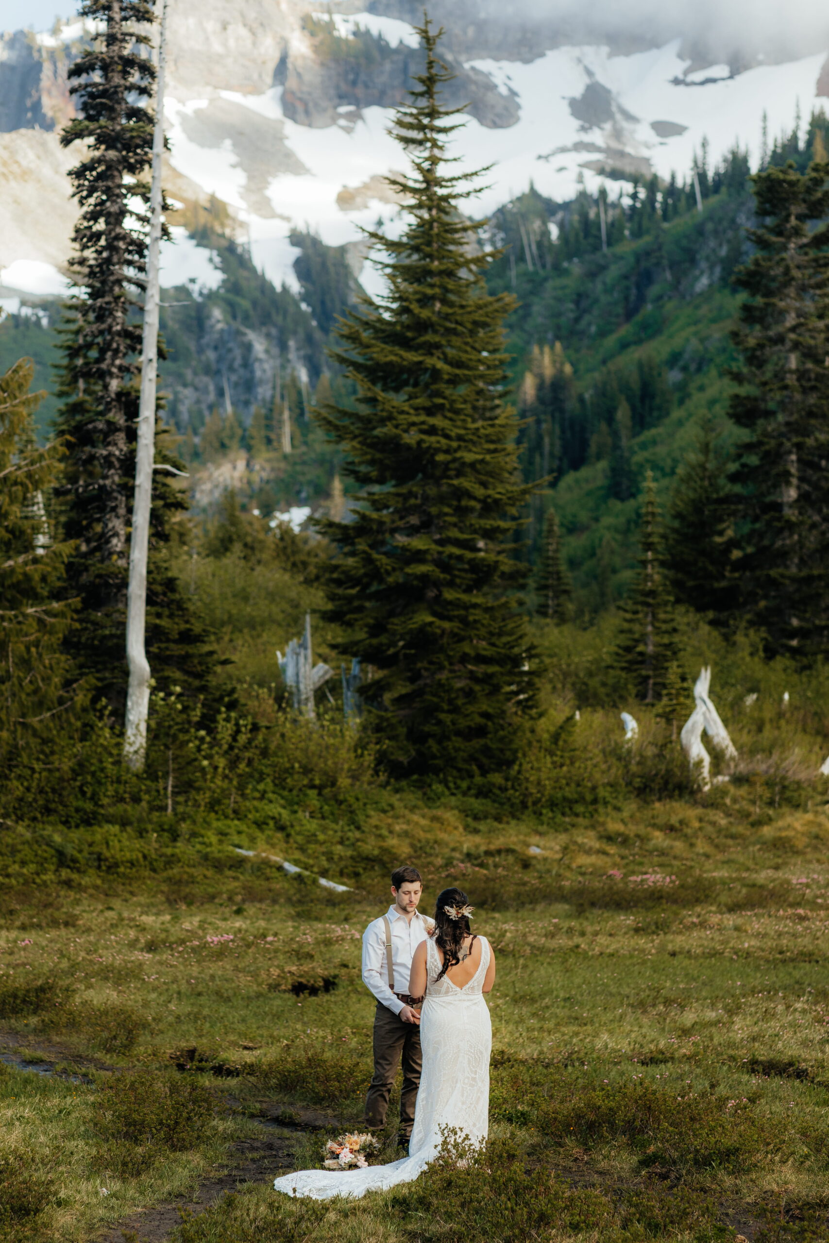 Couple stands in a valley during their elopement ceremony at Paradise Mt Rainier.