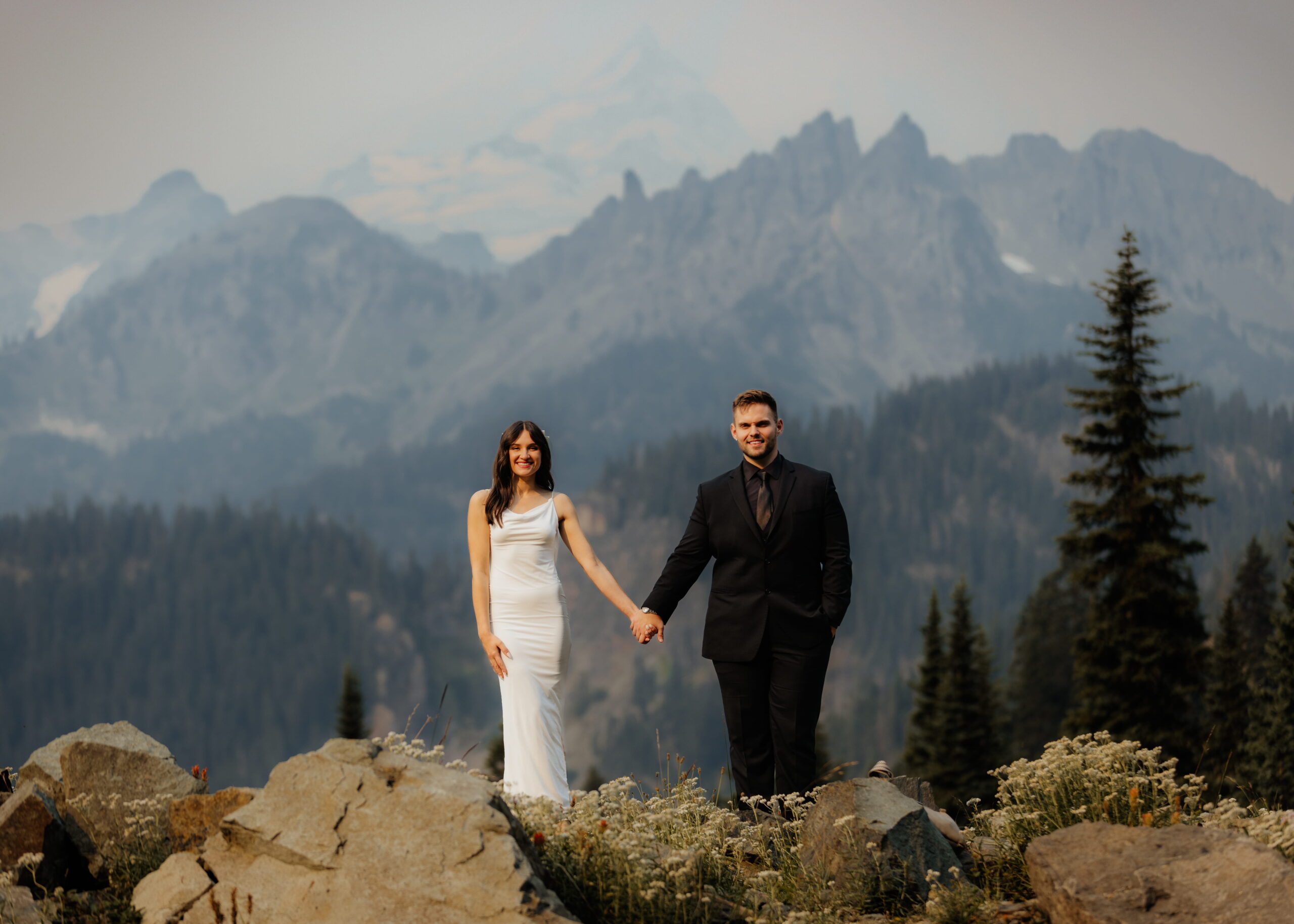Bride and groom hold hands during their Sunrise Mt Rainier elopement.