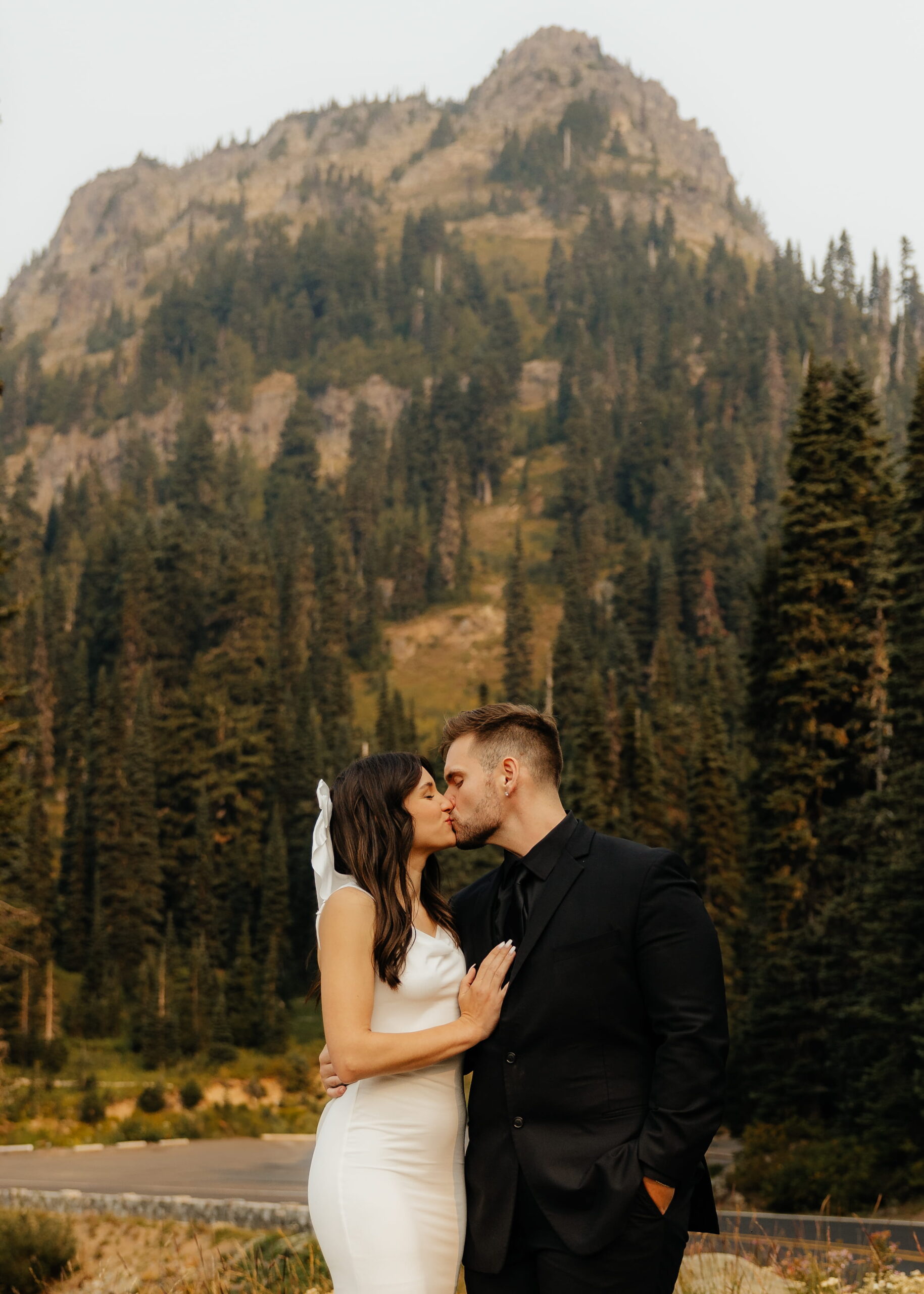 Newlyweds kiss during their Sunrise Mt Rainier elopement at Tipsoo Lake.
