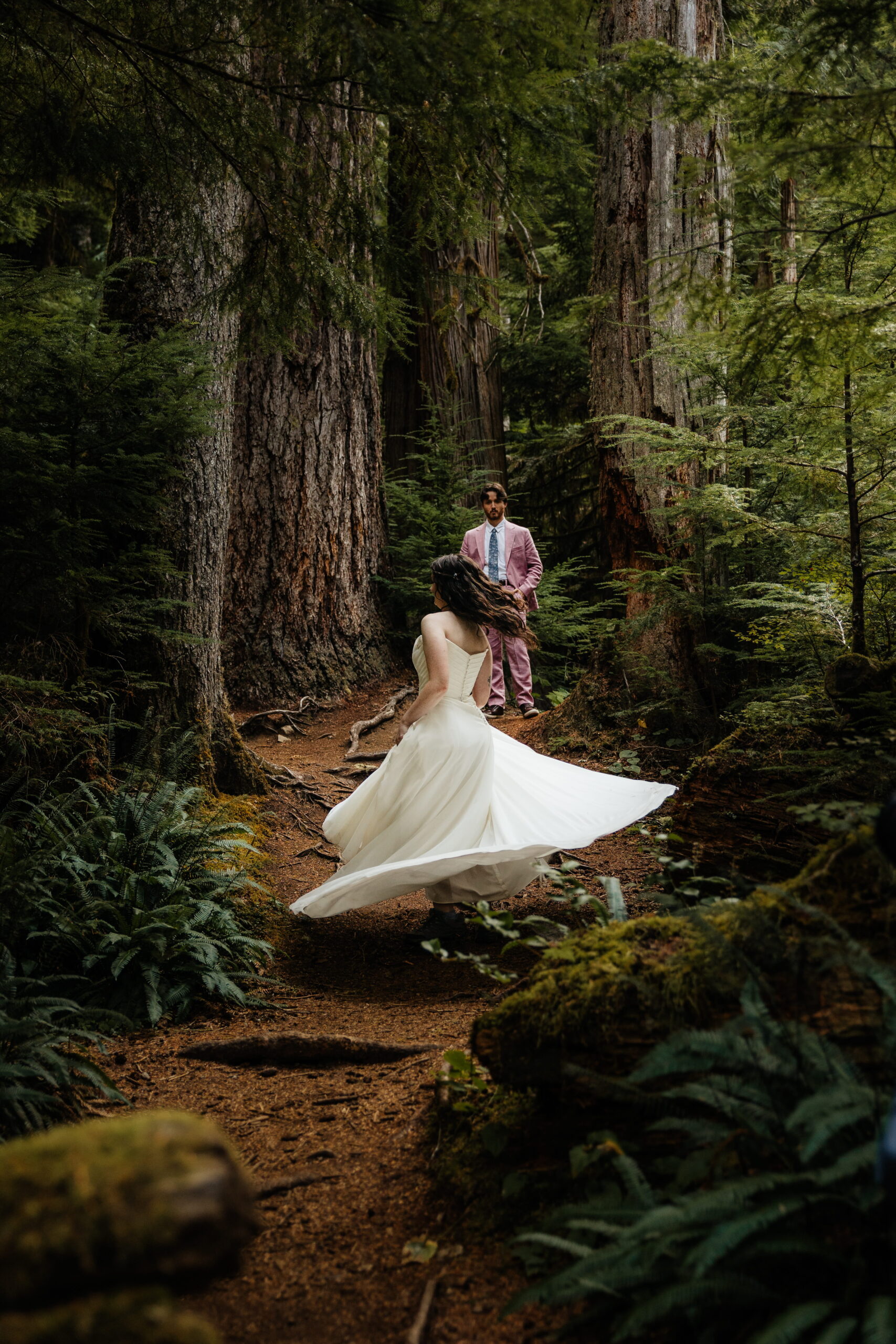 Newlyweds dance in the forest during their elopement in Washington.