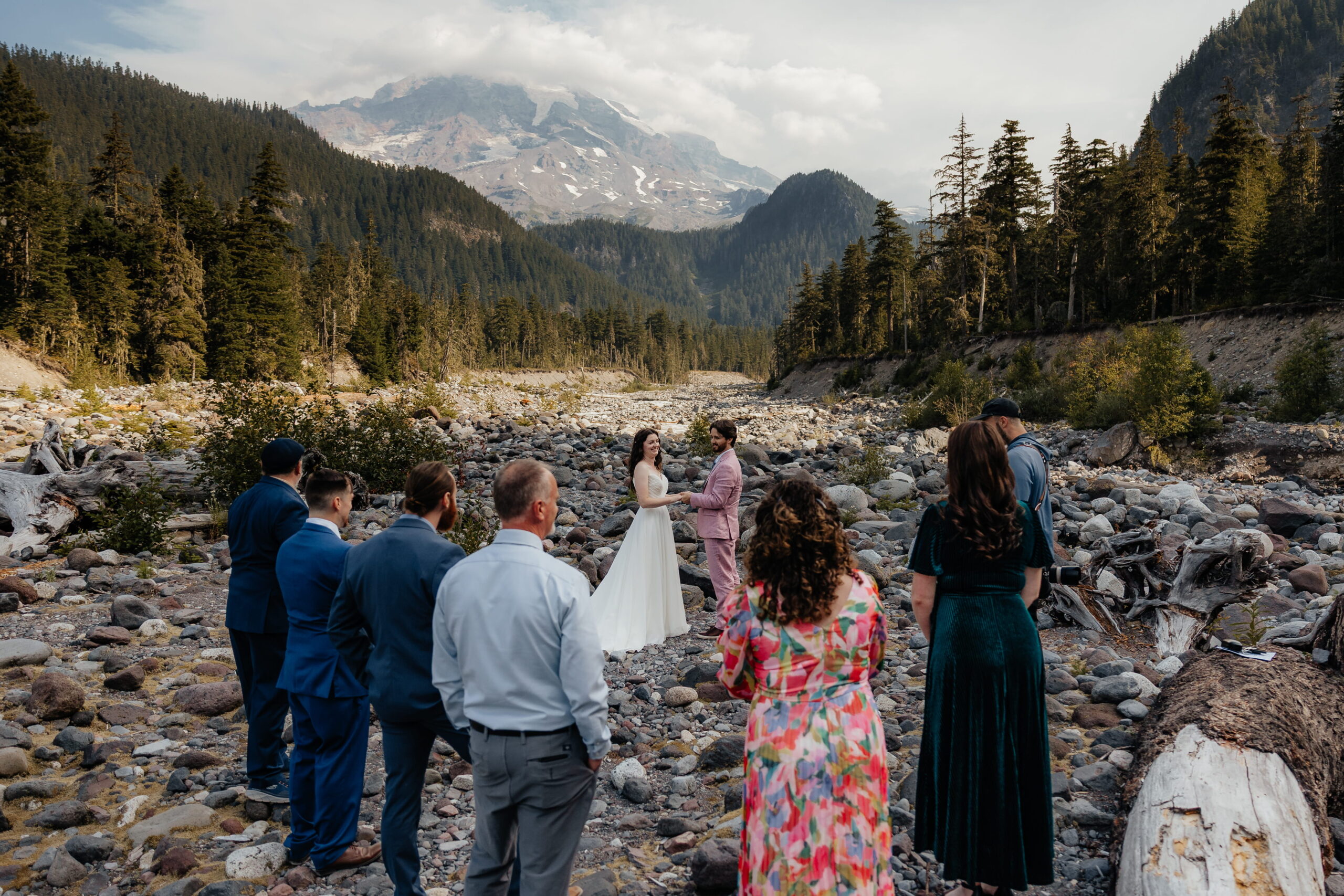 Guests gather around bride and groom during their Mt. Rainier wedding ceremony.