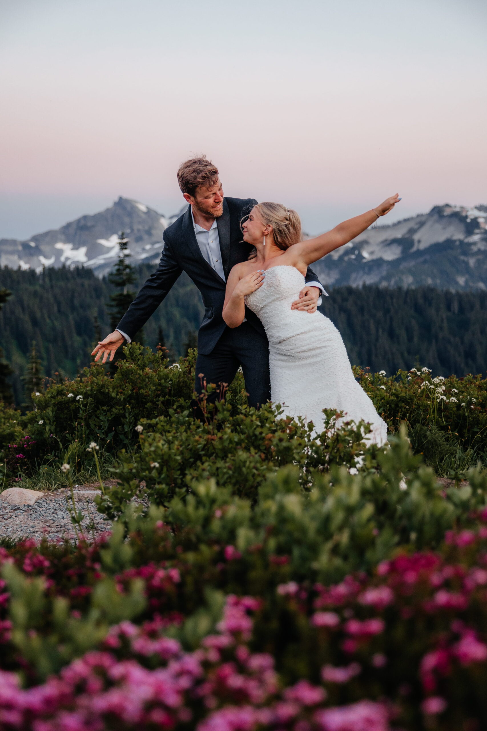 Newlyweds dance a choreographed dance in a wildflower field at Mt. Rainier.